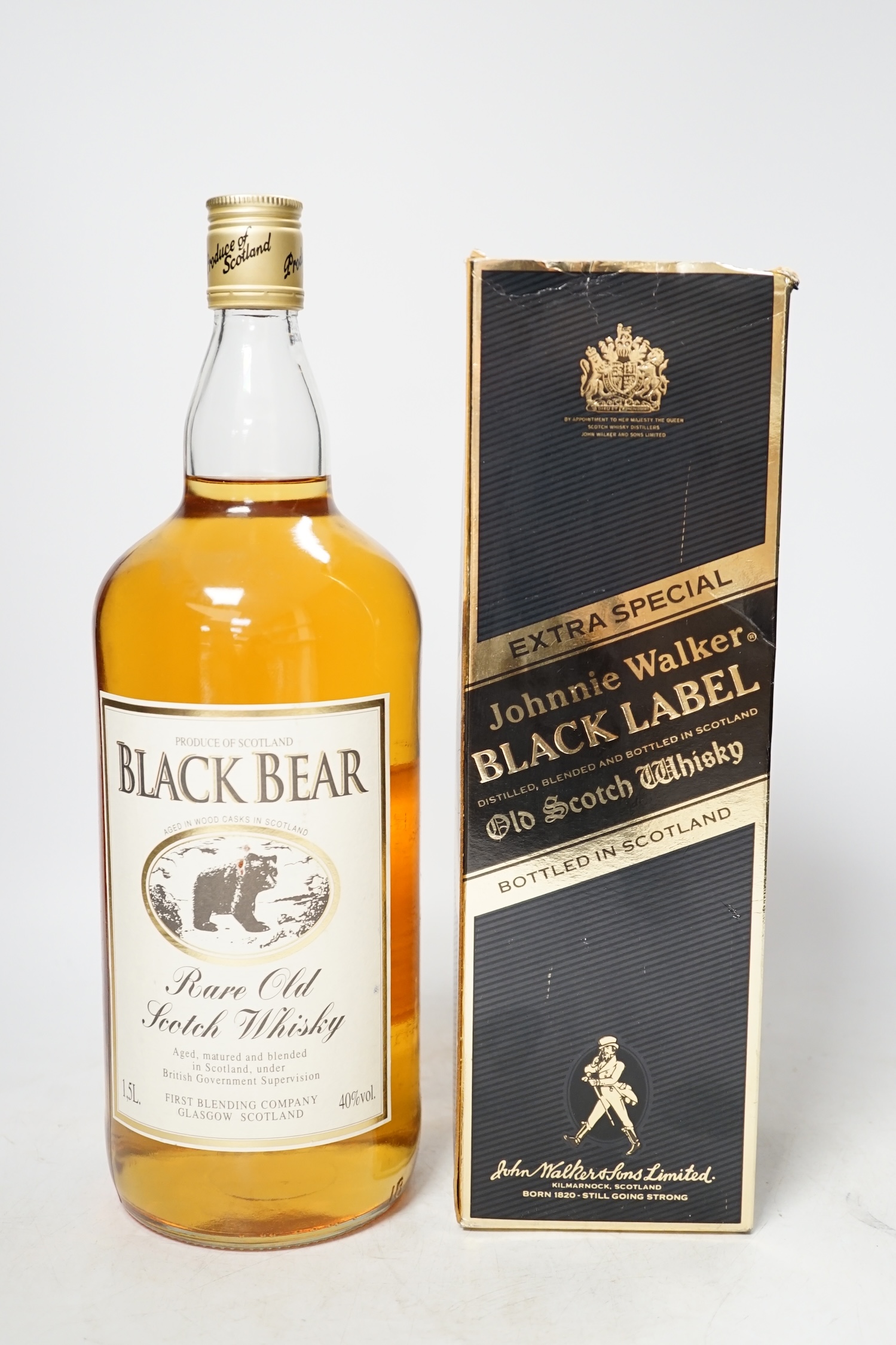 Two bottles of whisky comprising a 1.125L Johnnie walker black label and a 1.5L bottle of Black Bear. Condition - unopened, box a little tatty, storage unknown